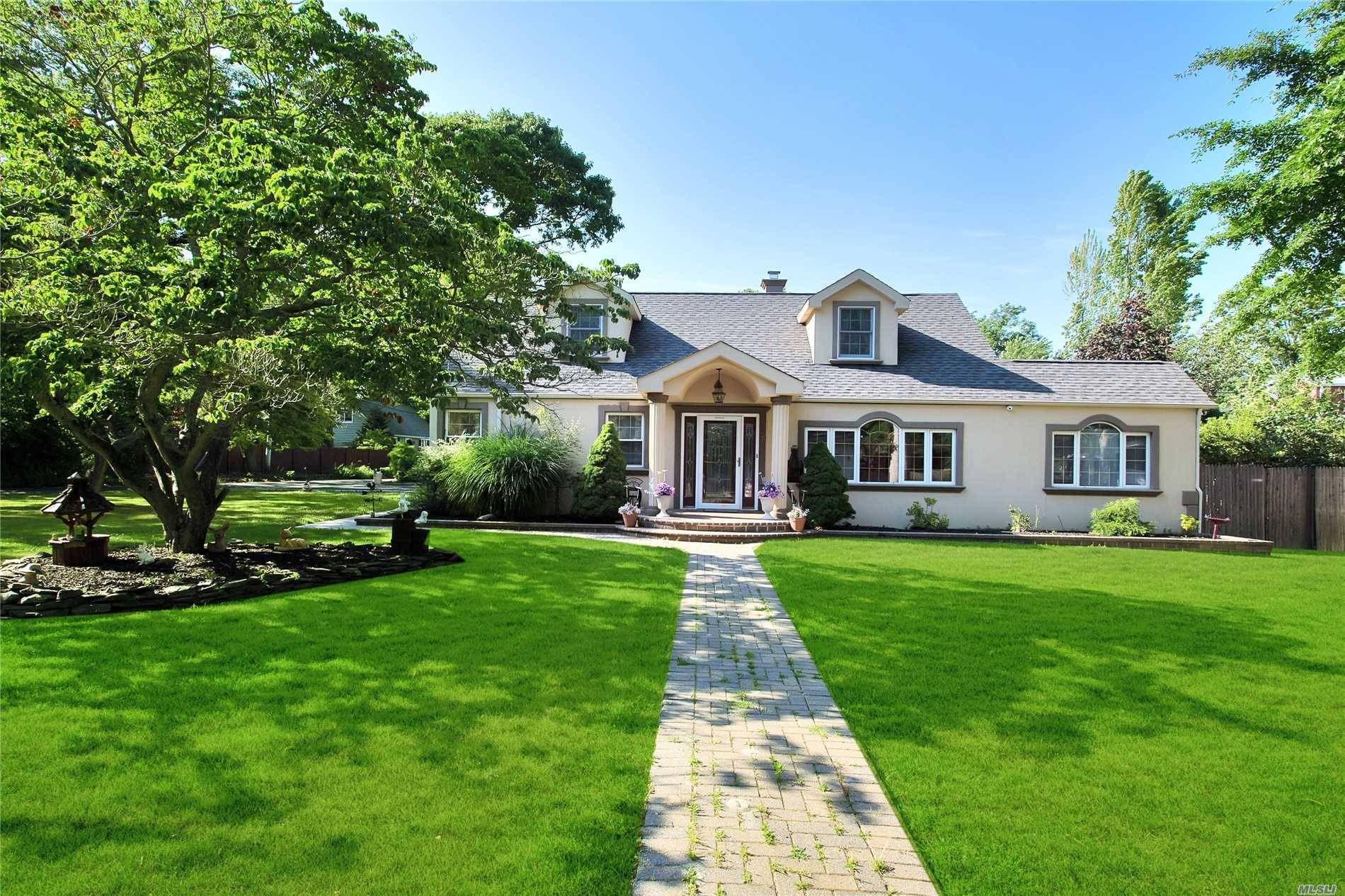 Charming Meditarannean Style Expanded Cape On Private Tree Lined Street South Of Montauk Hwy In East Islip.
