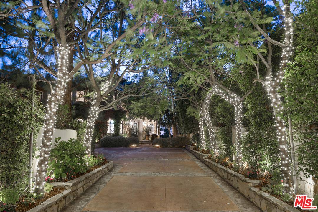 Tremendous privacy awaits in this picturesque Country French estate located in prestigious guard-gated community of 
