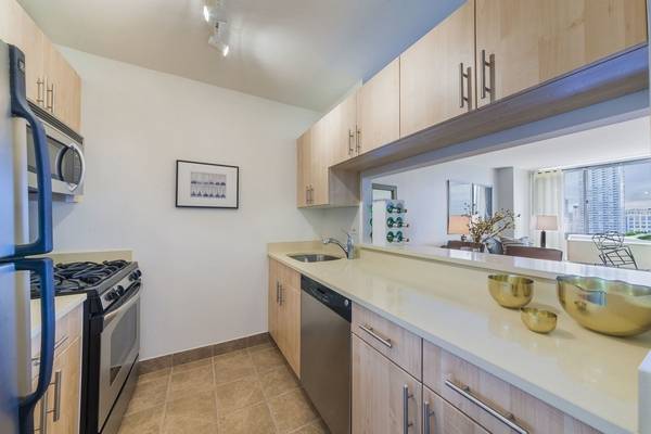 This 1BR 1BA features new wide plank flooring, a pass through kitchen with a breakfast bar, and ample closets.
