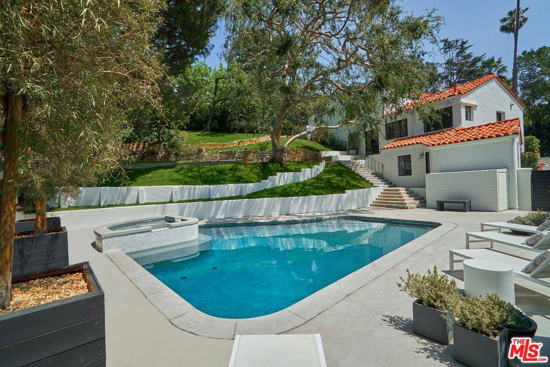 Perched atop a coveted promontory in the Hollywood Hills with views of the canyon