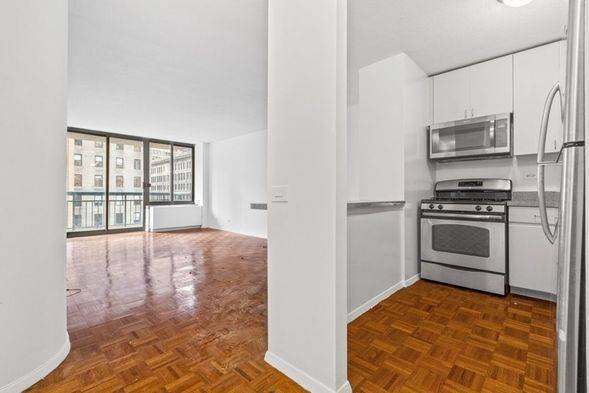 Full service building, private balcony, spacious living room with an open kitchen, PRIME location steps from Bryant Park, Penn Station, Murray Hill