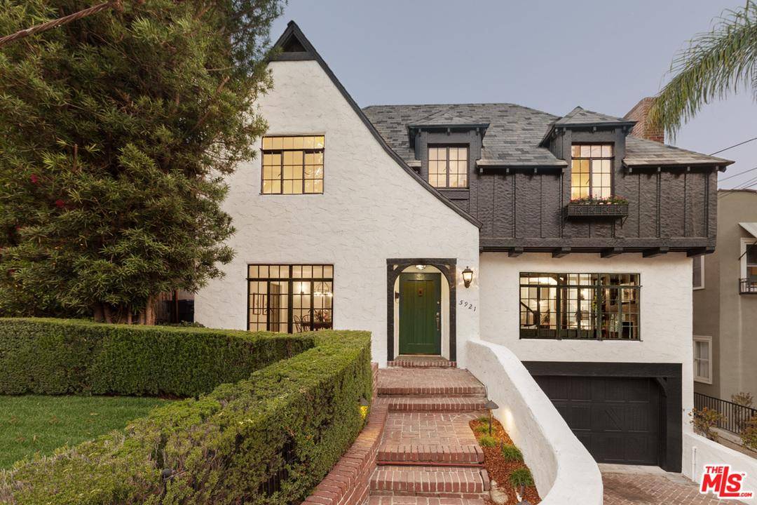 This Tudor revival conveys an immediate sense of refinement & tranquility