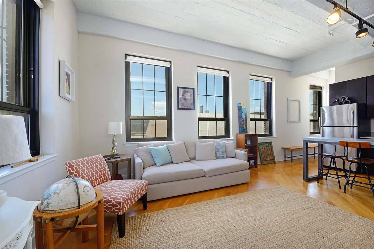 Mint condition loft-style 8 window condo at the sought-after Trolley House Lofts located in the heart of happening