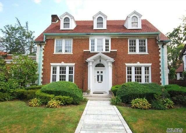 Dignity & Prestige Defines This Center Hall Brick Colonial Home.