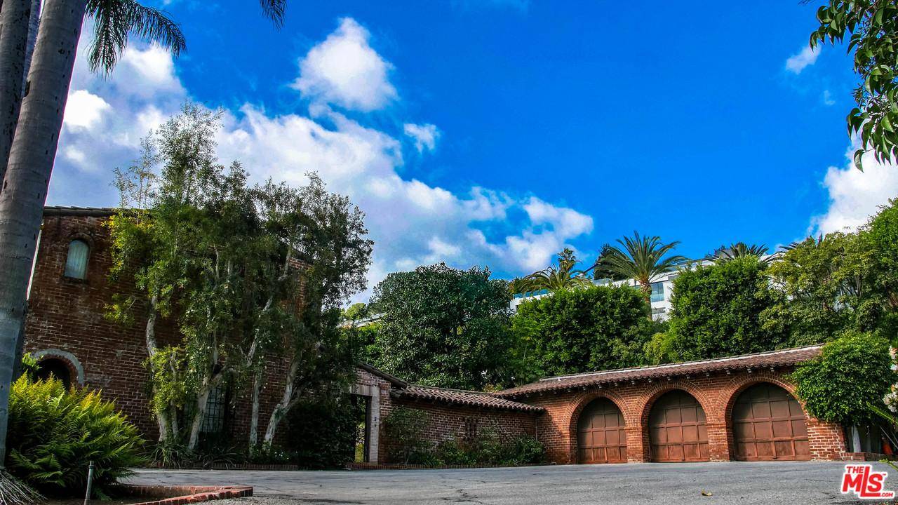 This elegant Spanish-style gem is situated in the center of Bel-Air on the coveted Nimes Road