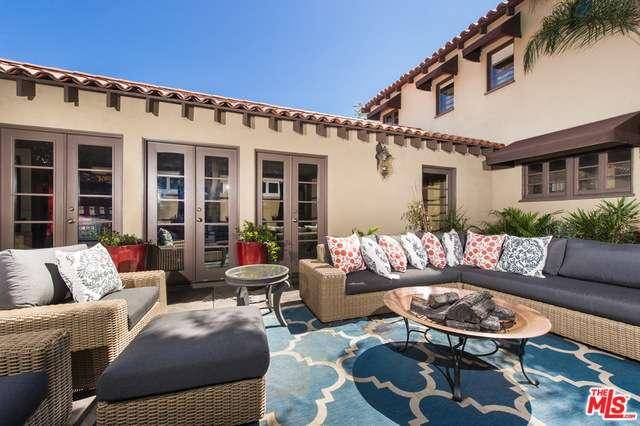 Updated two-story Spanish with authentic character featuring an impressive living room with vaulted wood beamed ceilings