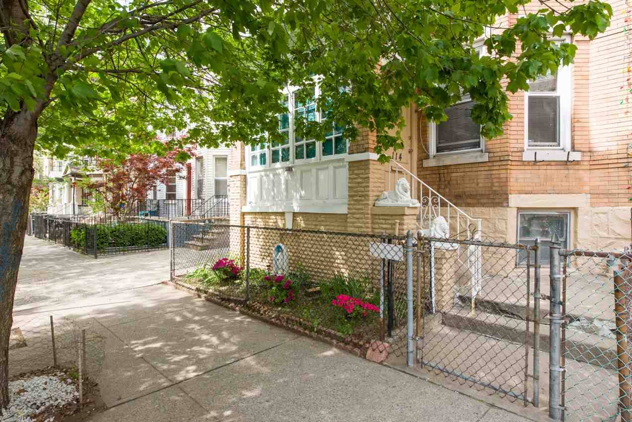 Nestled on a tree lined street in super hot Jersey City heights this brick two family home is waiting for you