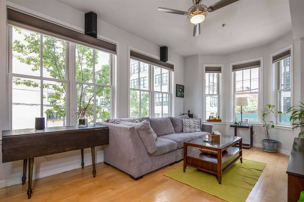 Welcome home to this sun-drenched corner unit w/ parking in an elevator bldg