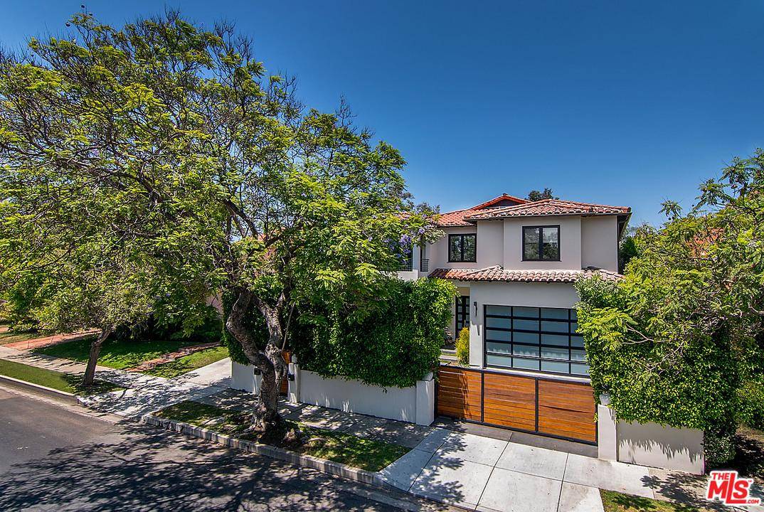 Beautiful Spanish Contemporary set behind lush hedges & private gated driveway & located on one of Beverly Grove's best extra wide streets