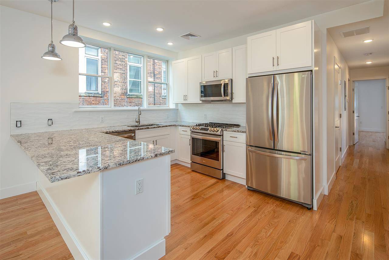 Stunning 3 bedroom + Den / 2 full bathroom condo with private patio and parking in the Heart of Weehawken