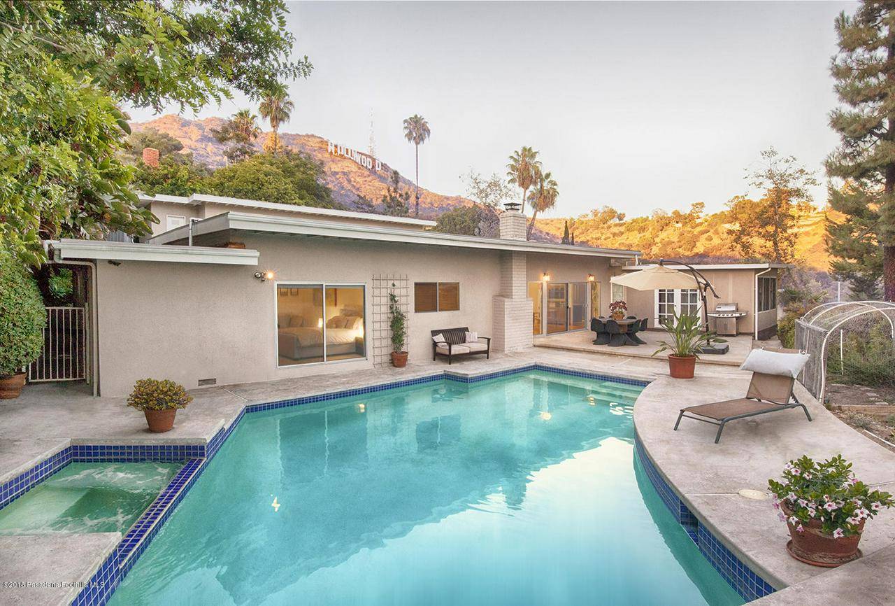 This exquisite 1965 mid-century modern home located among the prestigious Lake Hollywood Estates is a dream come true