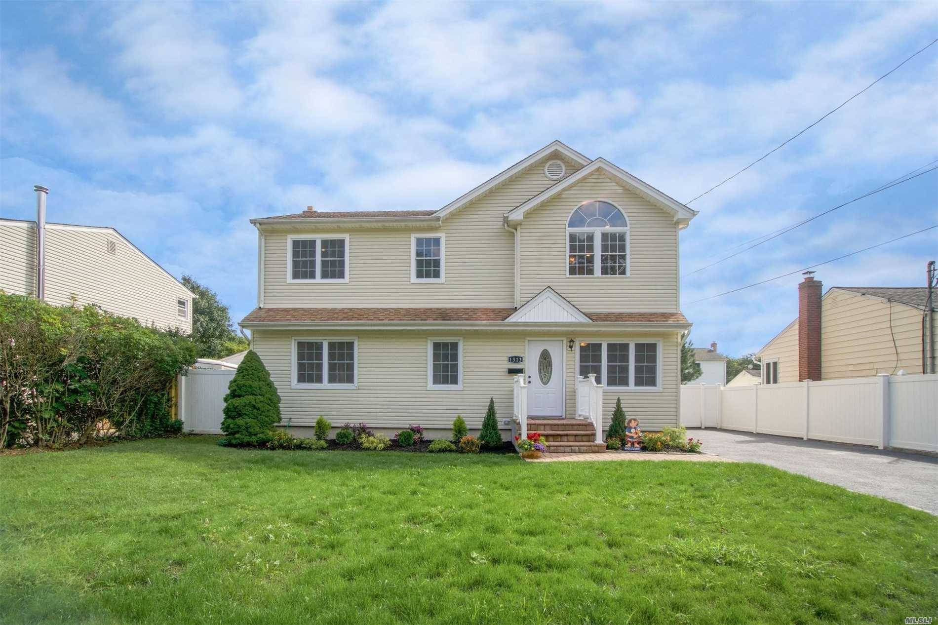 This Beautiful Totally Renovated & Spacious Colonial Boasts 4 Bedrooms, 4 Full Baths, Hw Floors Throughout.