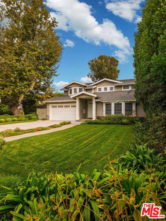 Set back from the street on a gracious lot with mature secluded landscaping
