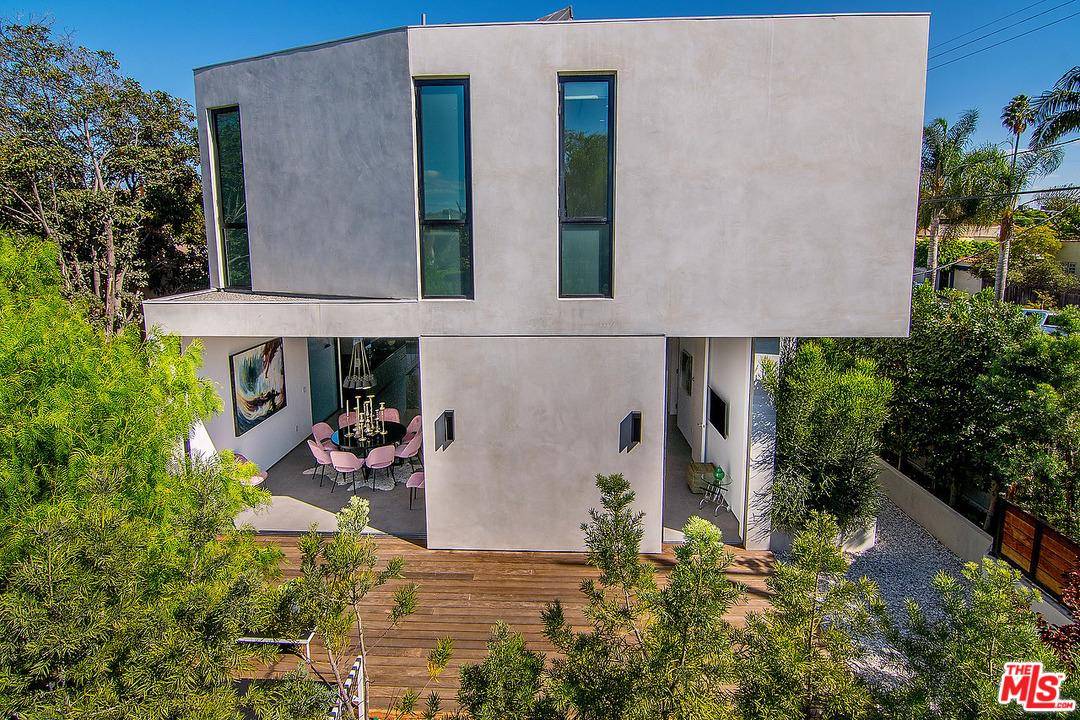 A distinctive private and gated modern home w/an elevator to a rooftop deck w/spa