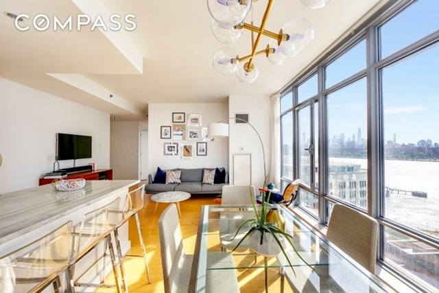 This stunning corner condo, with a wall of windows, is filled with light and displays open views of the Williamsburg Bridge, the East River and Brooklyn.