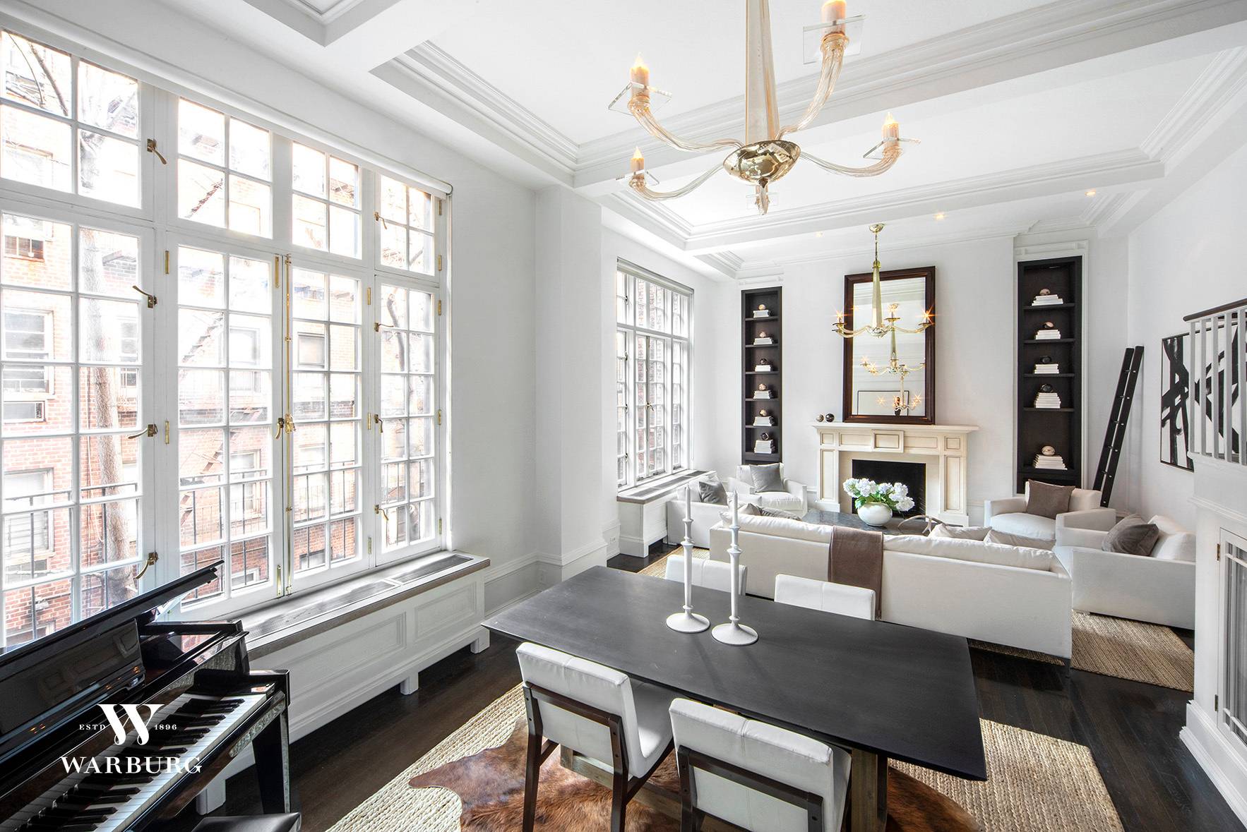 Dramatic double height ceilings and oversized casement windows define this mint condition one bedroom duplex apartment at Morgan Studios, a full service prewar cooperative building.