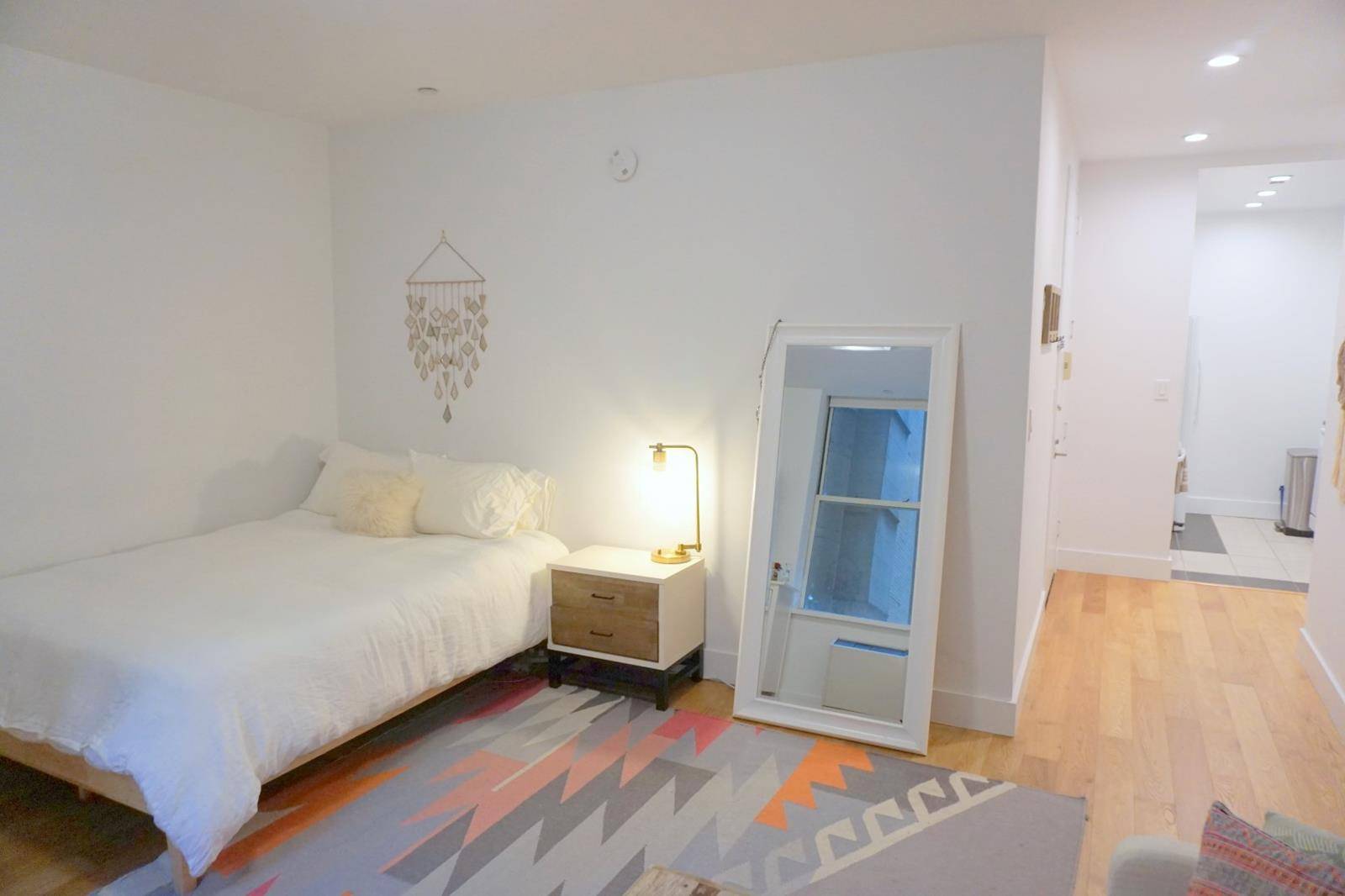 Spacious TRIBECA STUDIO with high beamed ceilings, great closet space, plank flooring, granite kitchen with stainless steel appliances and large windows.