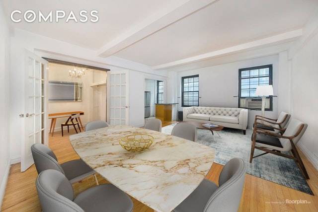 Enjoy prewar details and expansive living spaces in this spacious two bedroom plus bonus room home in a stately Gramercy Park cooperative.