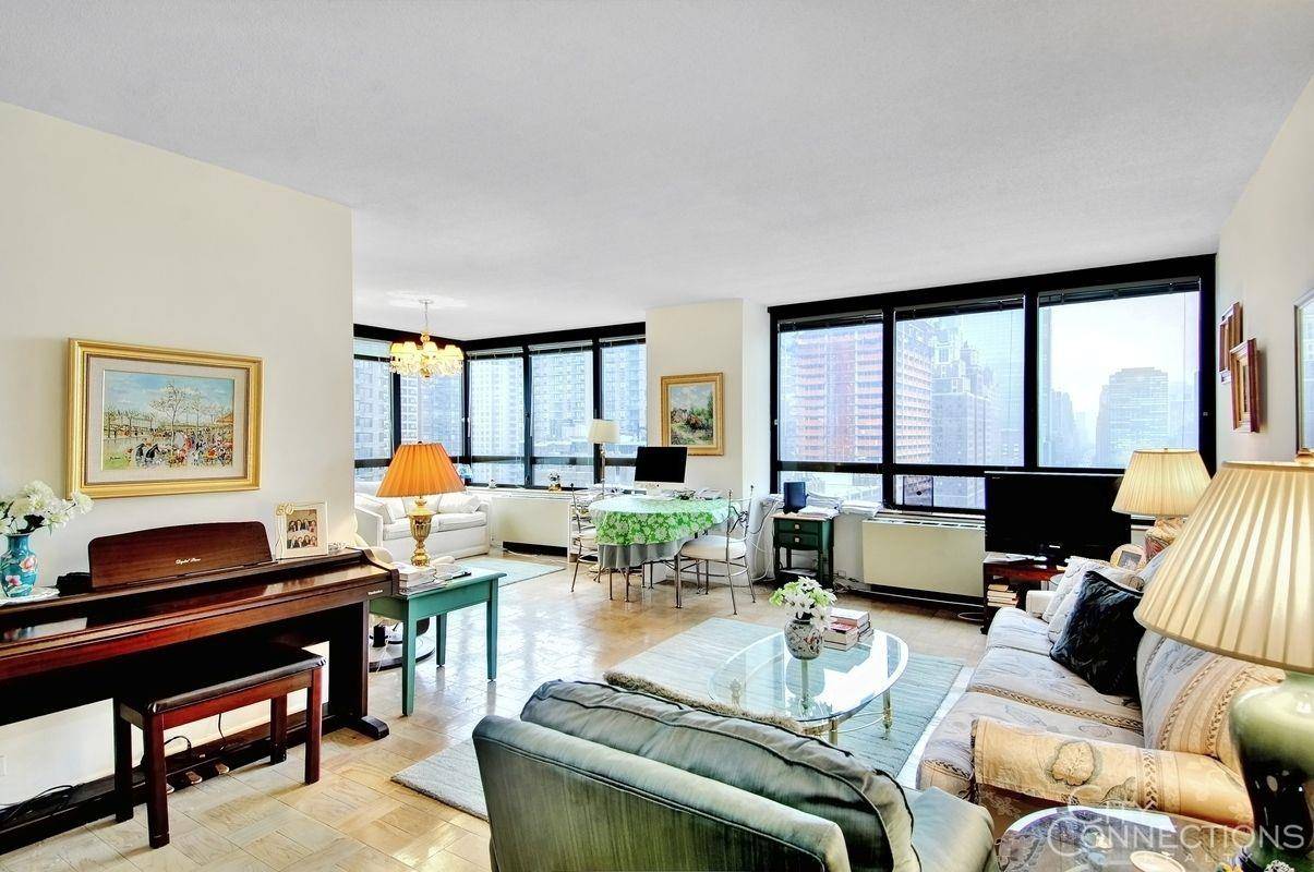 Massive flex 3 bedroom currently set up as a large living room without 2nd bedroom wall 2 bathroom apartment with sweeping views of the Empire State Building and Midtown Manhattan ...