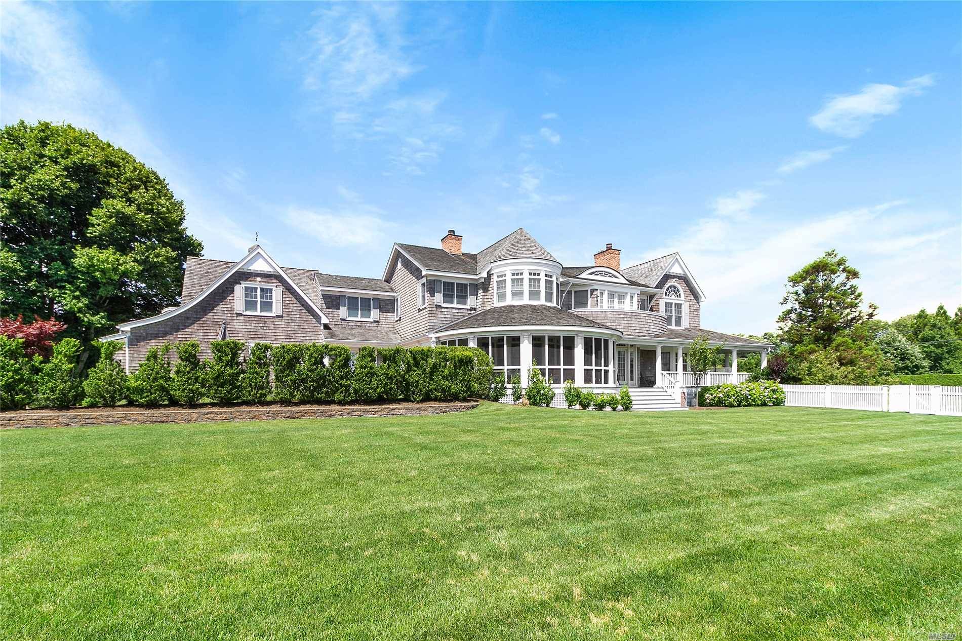 Enjoy the beautiful Estate area of Quogue South of the Highway is this well appointed constructed 7, 700 SF Nantucket home featuring 5 bedrooms, 8.