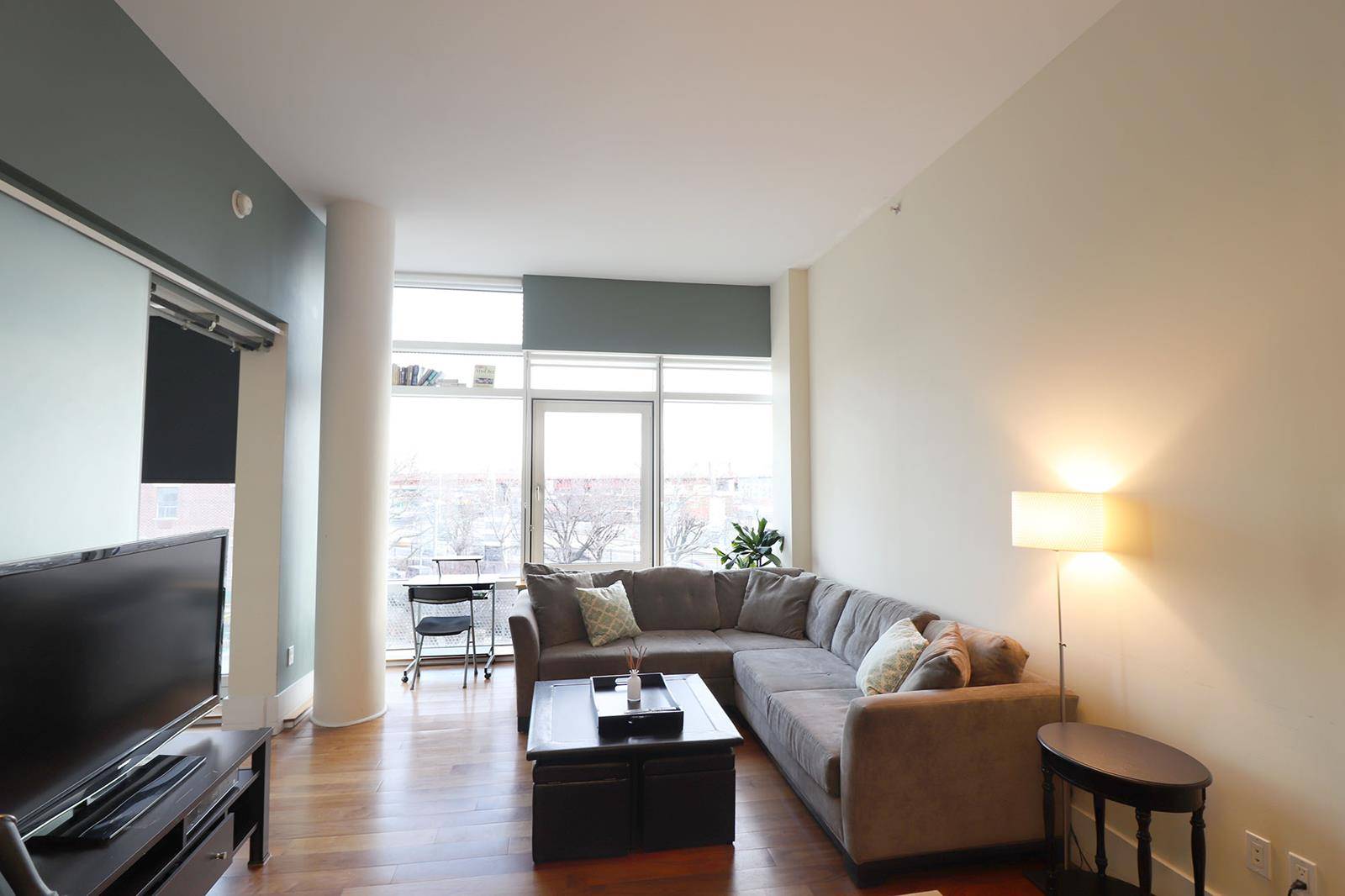 The apartment offers Lofty 11 2 foot ceilings, solid American walnut flooring, triple pane laminated windows.