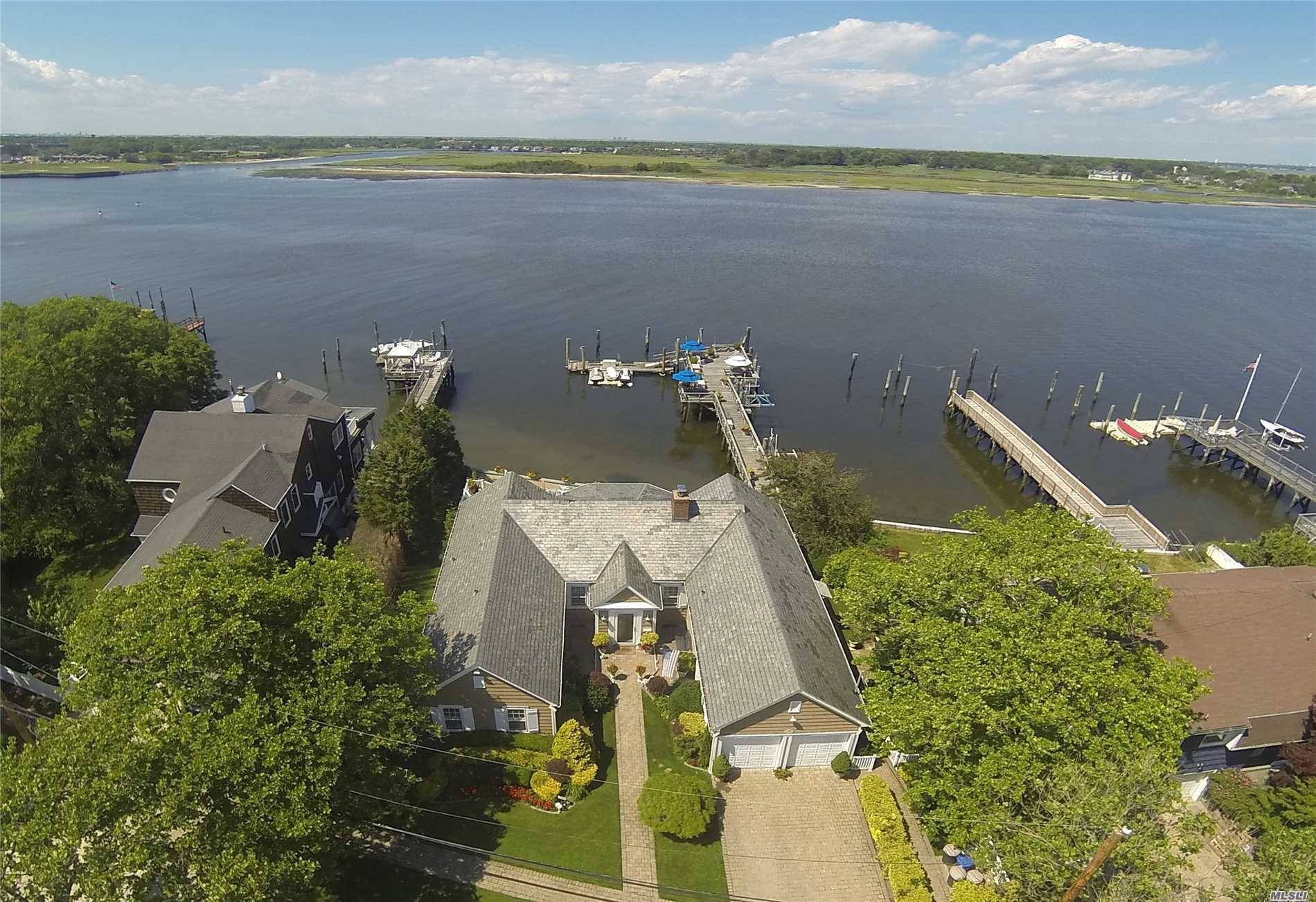 Newly Offered Timeless Waterfront 4 Bedroom, 4 Bath Home Situated On Over 8500 Sq.