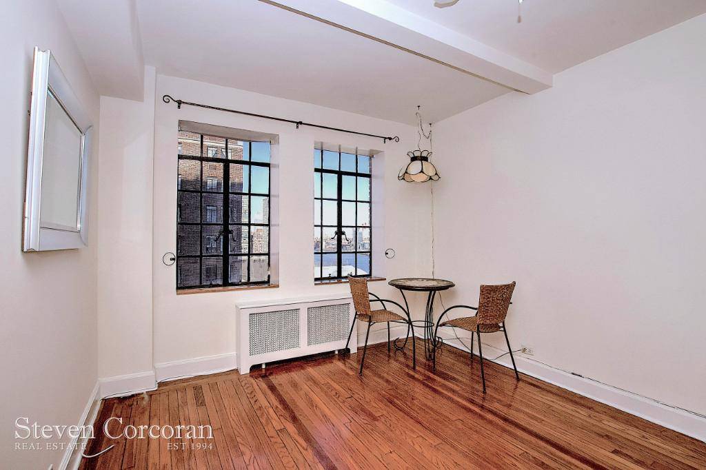 Bright Studio with Eastern exposure and million dollar views of the East River to the 59th Street Bridge.