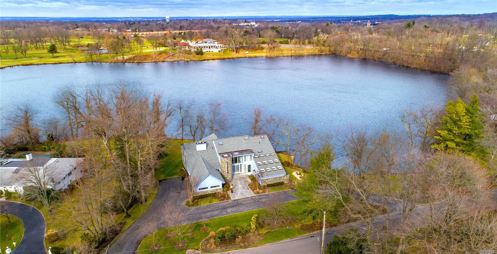 Stunning 7, 500 Sq Ft Contemporary Lakefront Home Situated On Approximately 1 Acre Of Park Like Property On The Only Waterfront Street In Lake Success.