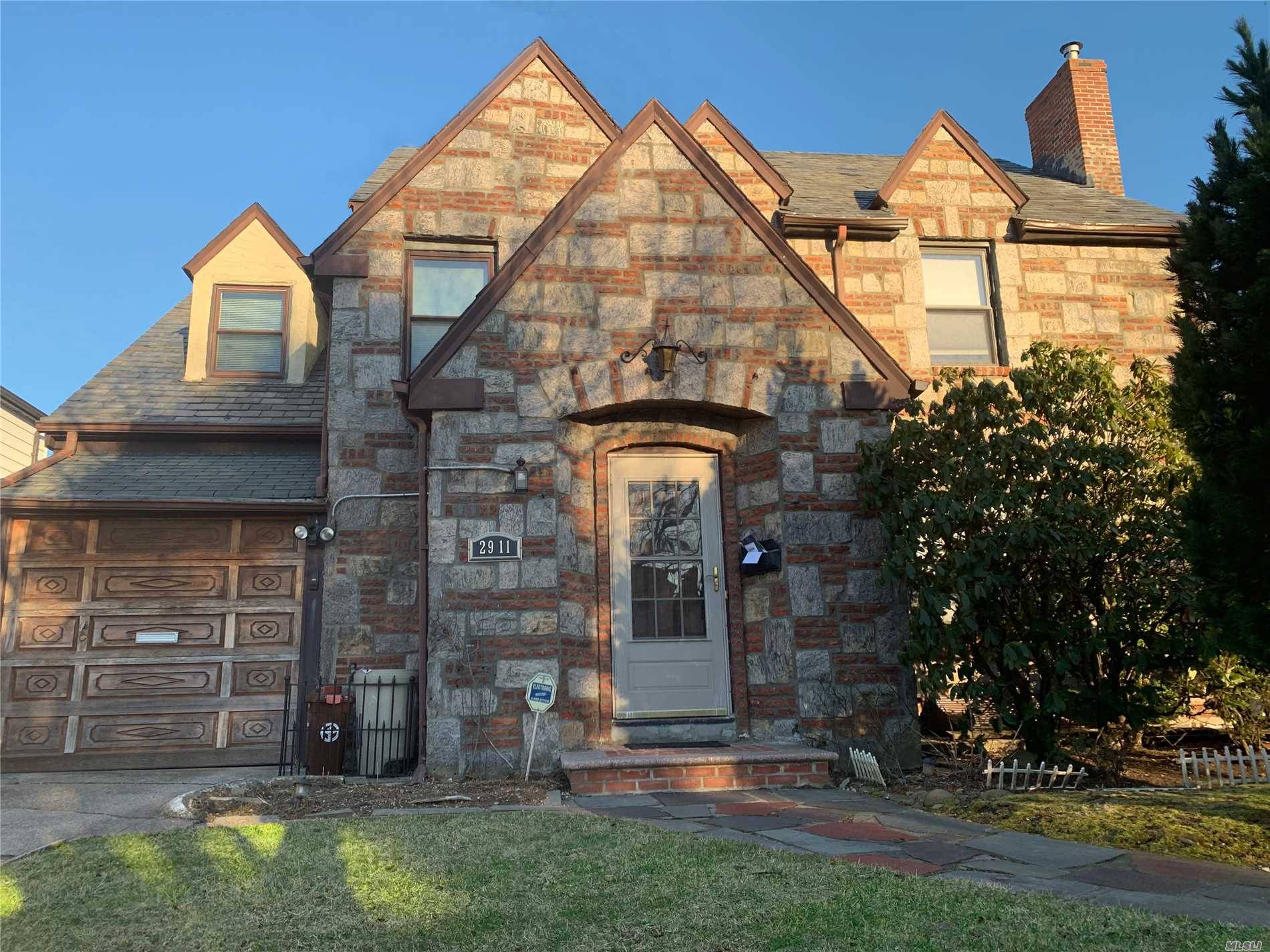 Beautiful Oversize Brick And Stone Tudor Located In The Heart Of North Flushing.