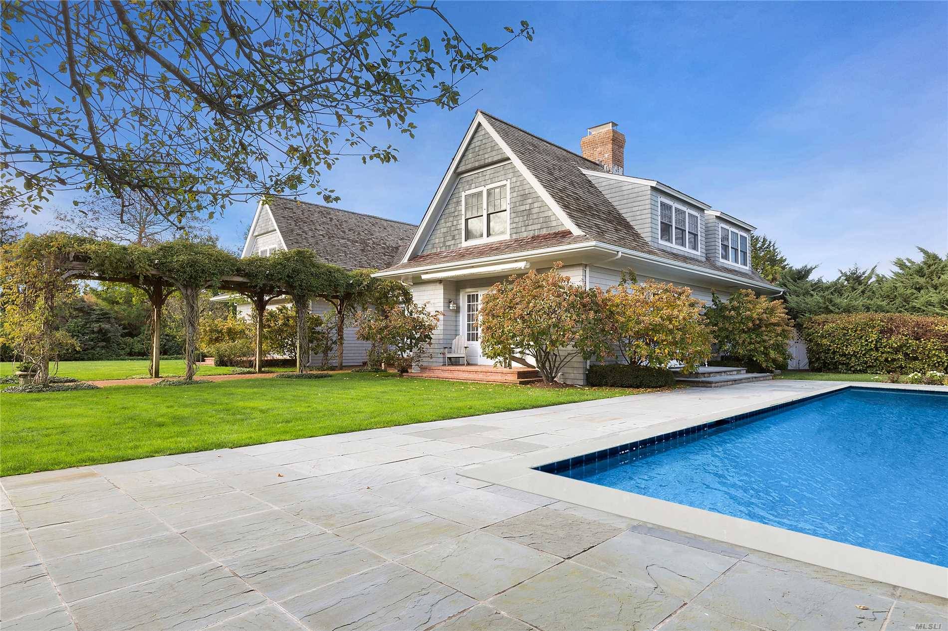 This Five Bedroom, Five And One Half Bath, Sagaponack Traditional Is Nestled On A Lush Acre, Surrounded By Mature Hedges, Hydrangeas, And Stunning Rhododendrons.