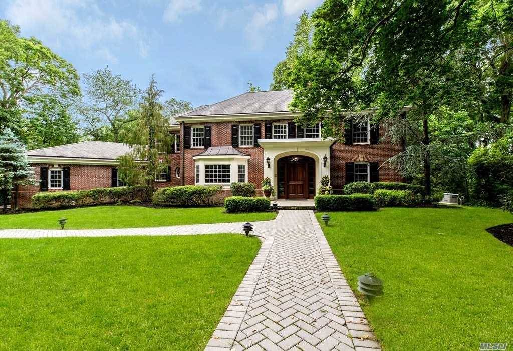 Magnificent Brick Center Hall Colonial Located On An Acre Of Private Lush Flat Property.