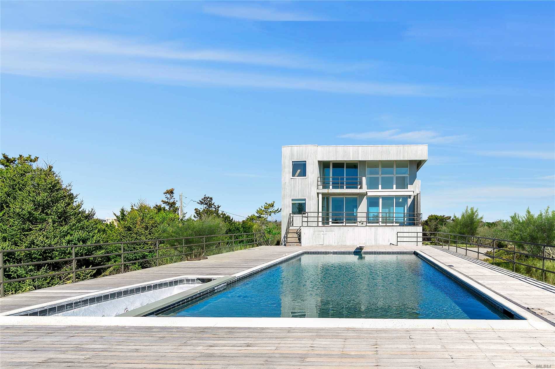 A truly magnificent contemporary sited on over 2 acres of Quogue Oceanfront.