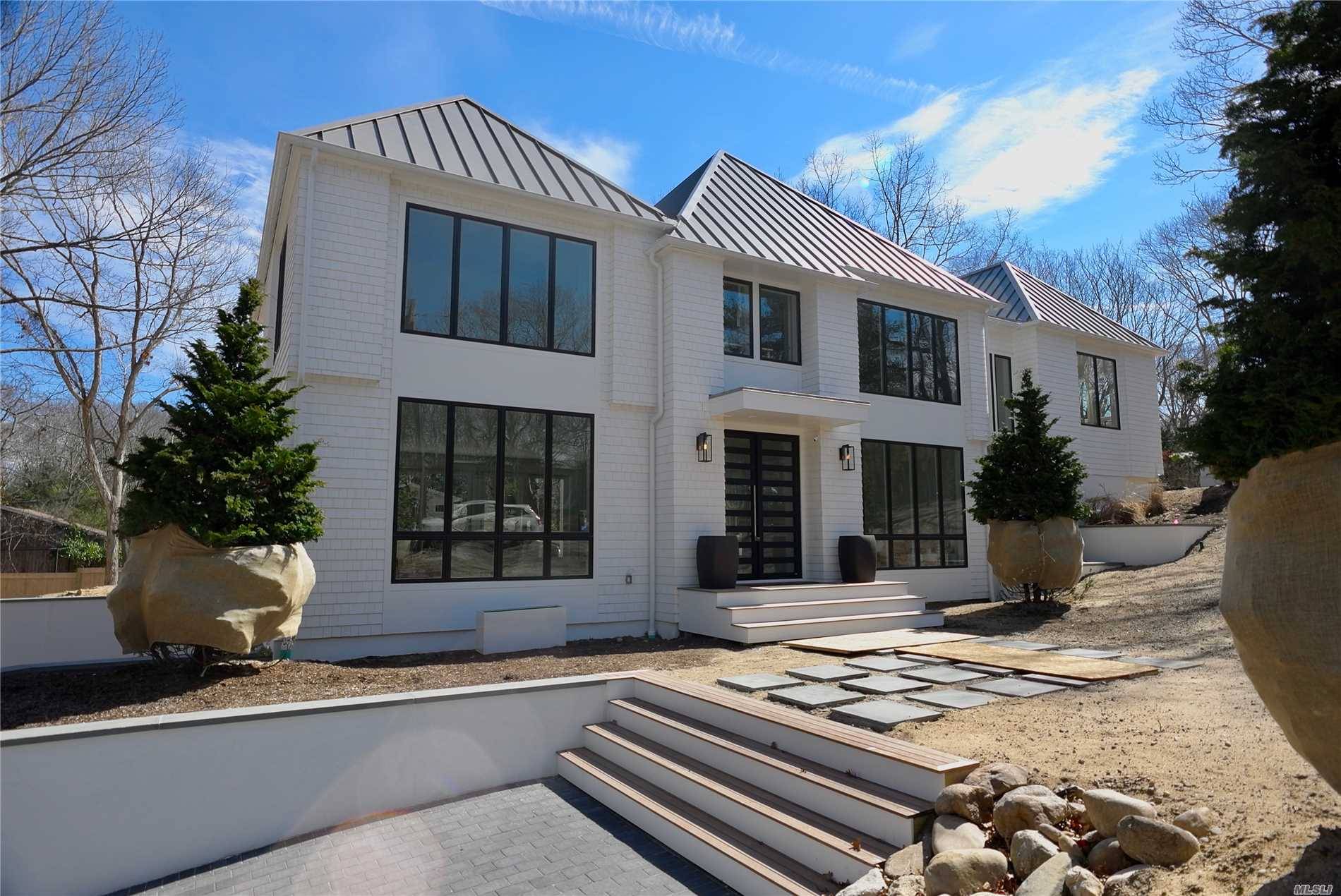 Situated in a private community within the Village of Sag Harbor, newly constructed 5 BR, 5.