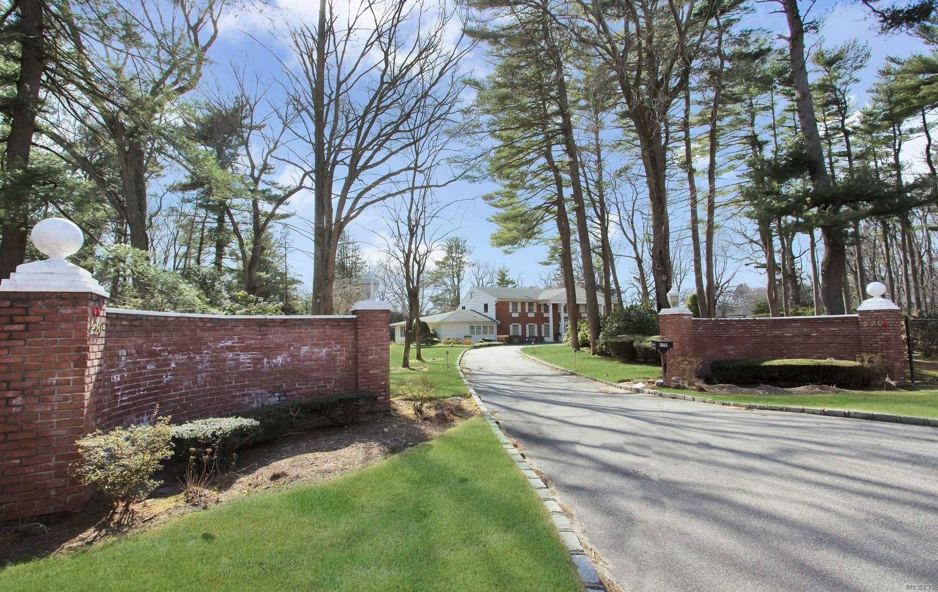 Gracious brick home sited on 2 magnificent acres in Old Westbury.