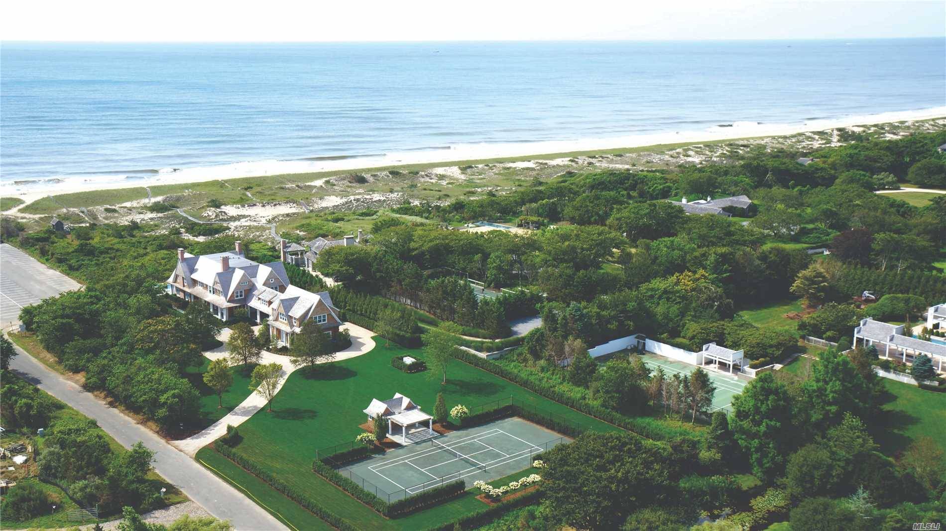 East Hampton oceanfront estate on 3 acres, with an infinity pool, tennis and a beachfront bungalow, is located south of the highway.