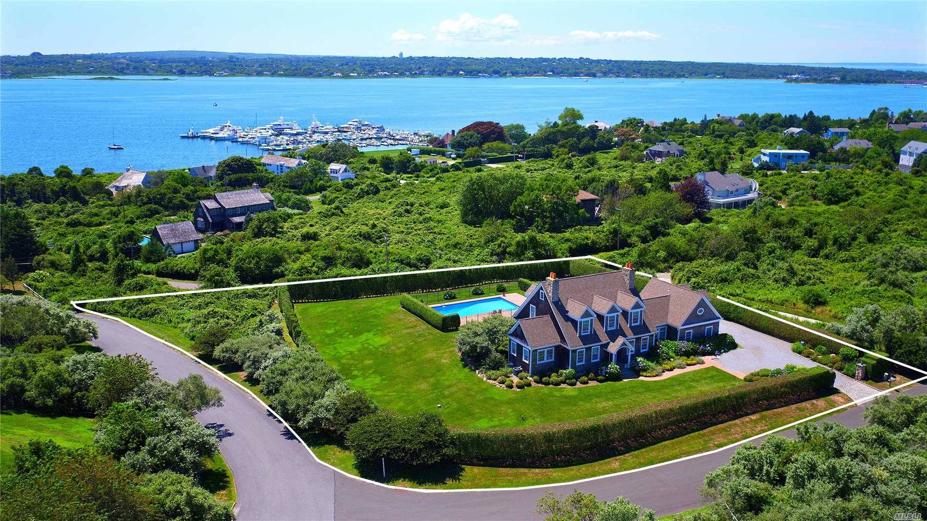 Step in to this immaculate light filled gated home with breathtaking views of Lake Montauk.