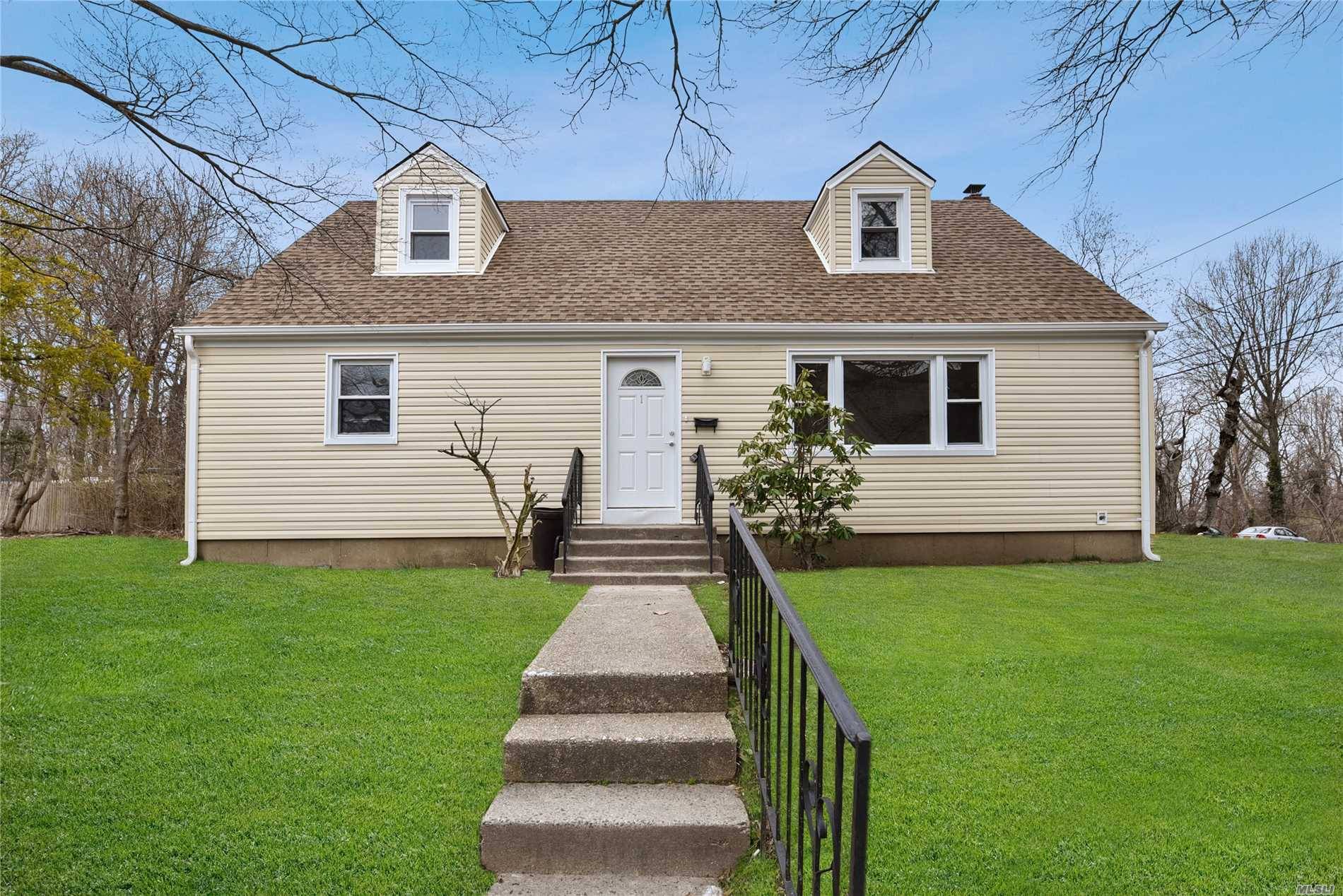 Glen Cove. Nicely Renovated Cape Home, New Kitchen with New Appliances, New Roof, New Siding, 4 Bedrooms, 3 Full Baths, Wood Floors, Tile Finished Basement with a Full Bath.
