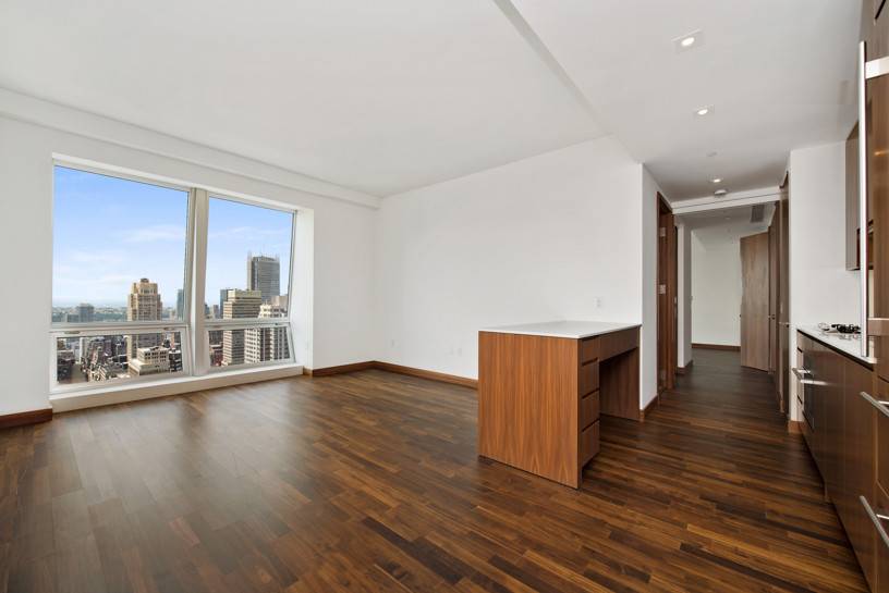 Stunning, Fifth Avenue high floor condominium residence, located atop the five star Langham Place Hotel, with magnificent views of the city and Hudson river from floor to ceiling windows.