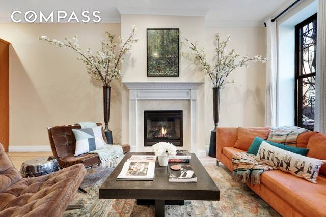 Gracious 2 bed 2 bath duplex in brownstone condo conversion featuring high ceilings, gas fireplace, energy efficient ductless AC, vented W D and cooking hood, balcony off master bedroom, and ...