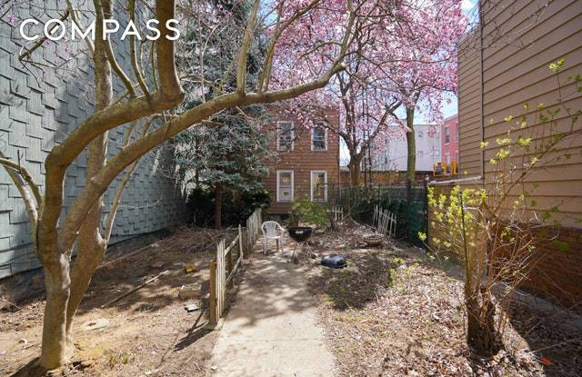 A unique set back house perfectly situated on a tree lined block in Greenpoint.