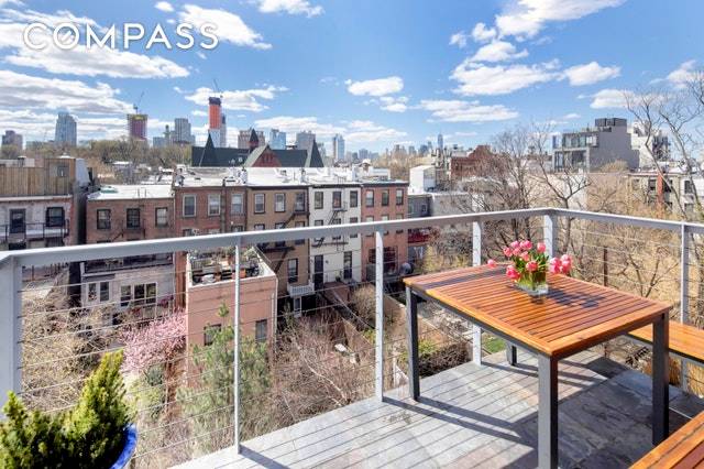 This happy, mint condition two bedroom two bathroom condominium boasts a sunny great room with a wall of windows, and an adjacent outdoor space perfect for dinners al fresco.