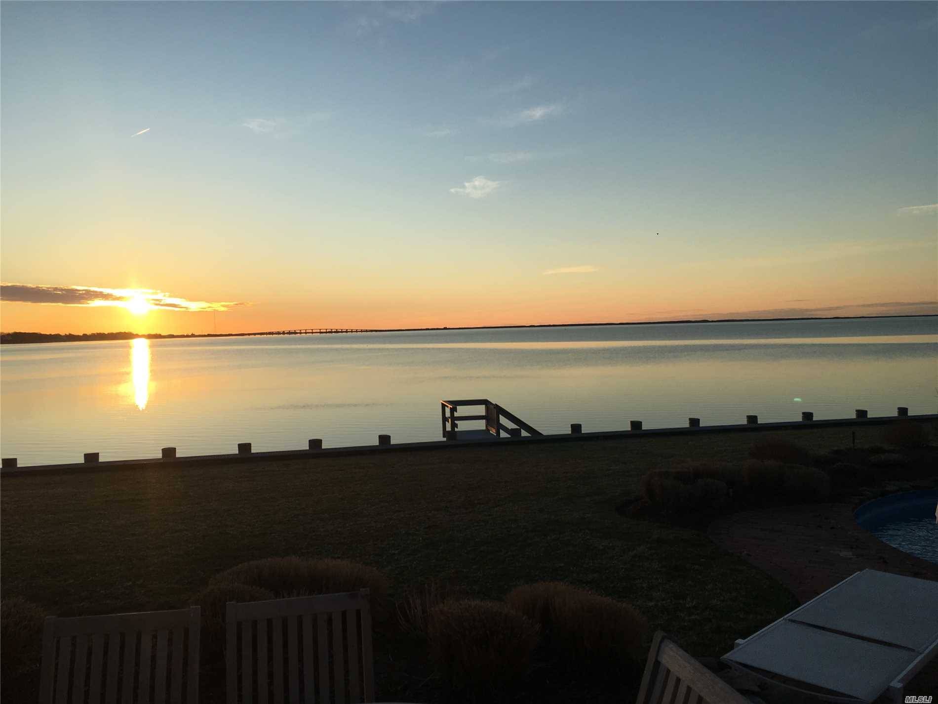 Watch the sun rise over Shinnecock Bay from almost every room in this very special and immaculate home tucked away in an upscale community in East Quogue.