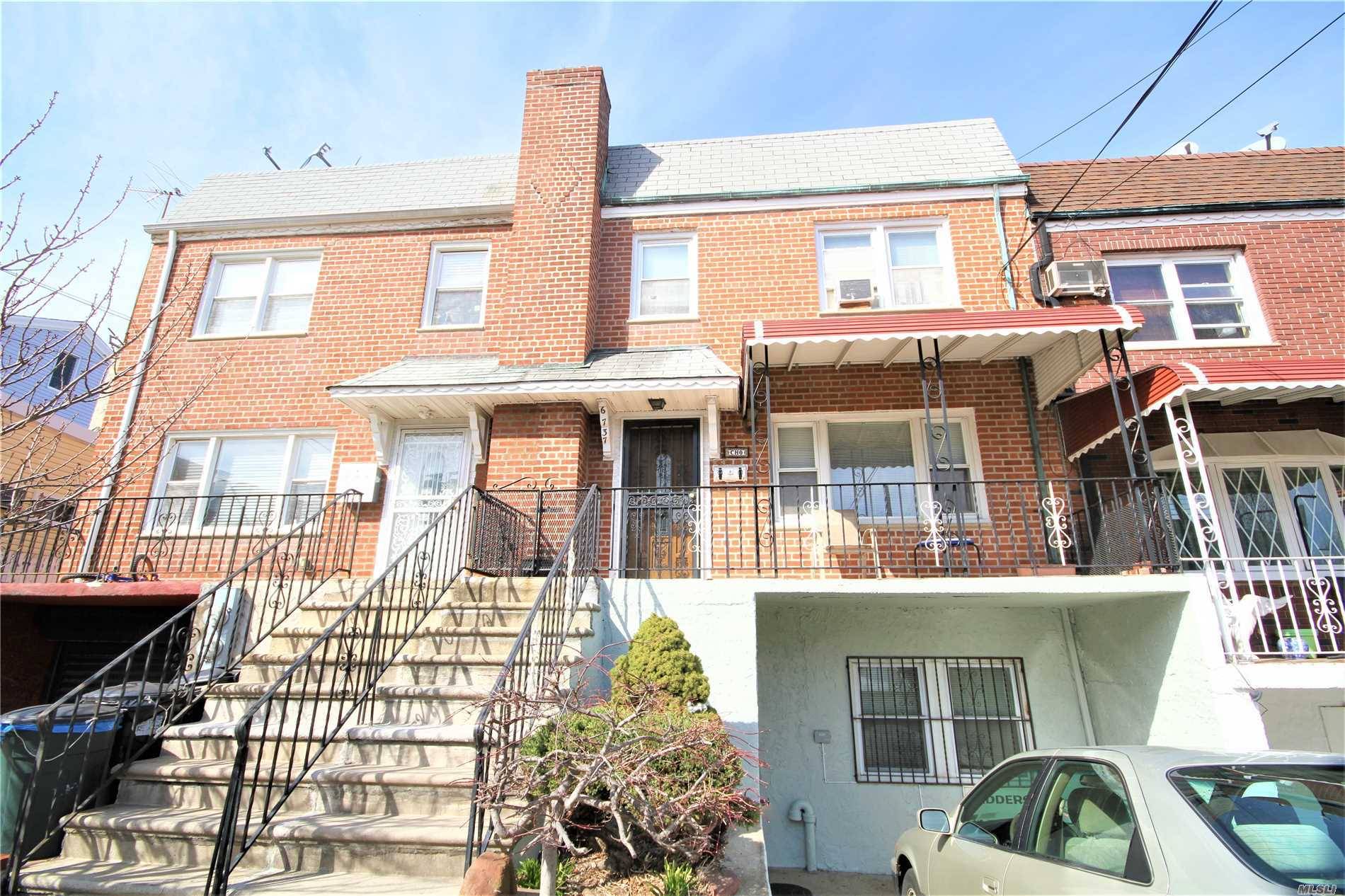 Maspeth, attached single family brick side hall colonial with a spacious 20' by 37' building size.