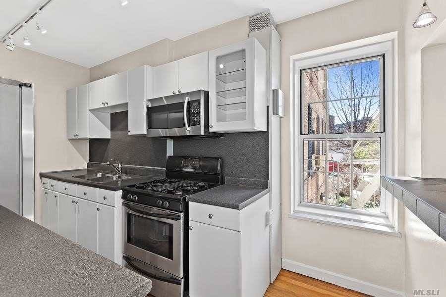 Woodside Astoria border, sunny 3BR in Boulevard Gardens features windowed kitchen with breakfast bar, wind din'g w French doors leading to LR.