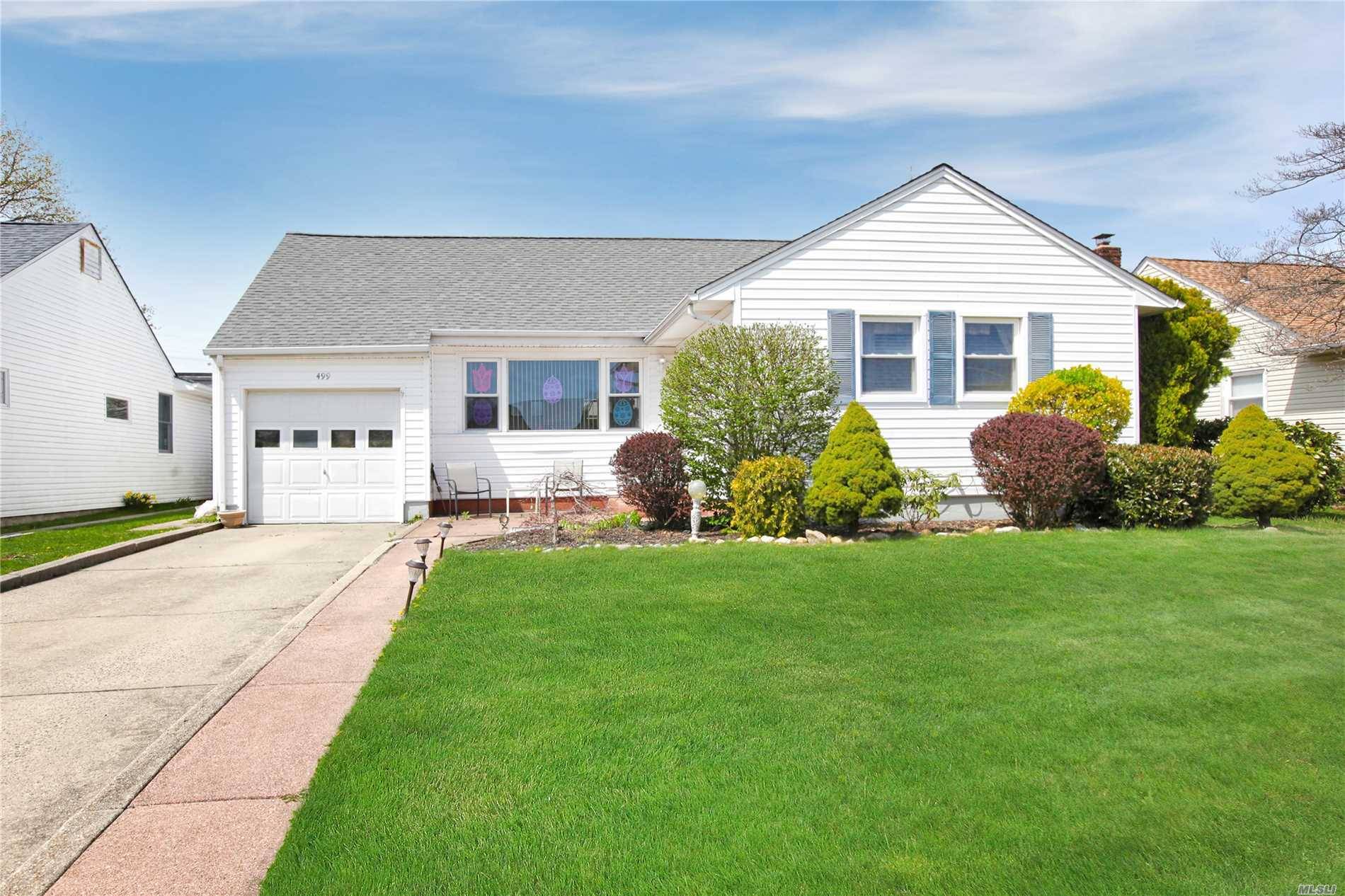 Great Ranch in Bethpage in lovely neighborhood with sidewalks and lamp posts.