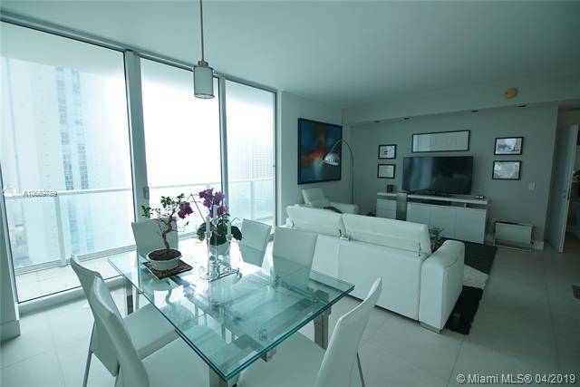 Enjoy breathtaking bay views in this tastefully FULLY FURNISHED and contemporary 2 bedroom corner unit at Met 1