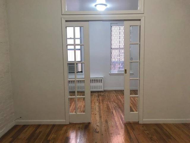 Quiet Junior 1 bedroom that offers exposed brick fireplace, sliding french pocket doors, hardwood floors, nice kitchen with a breakfast bar.