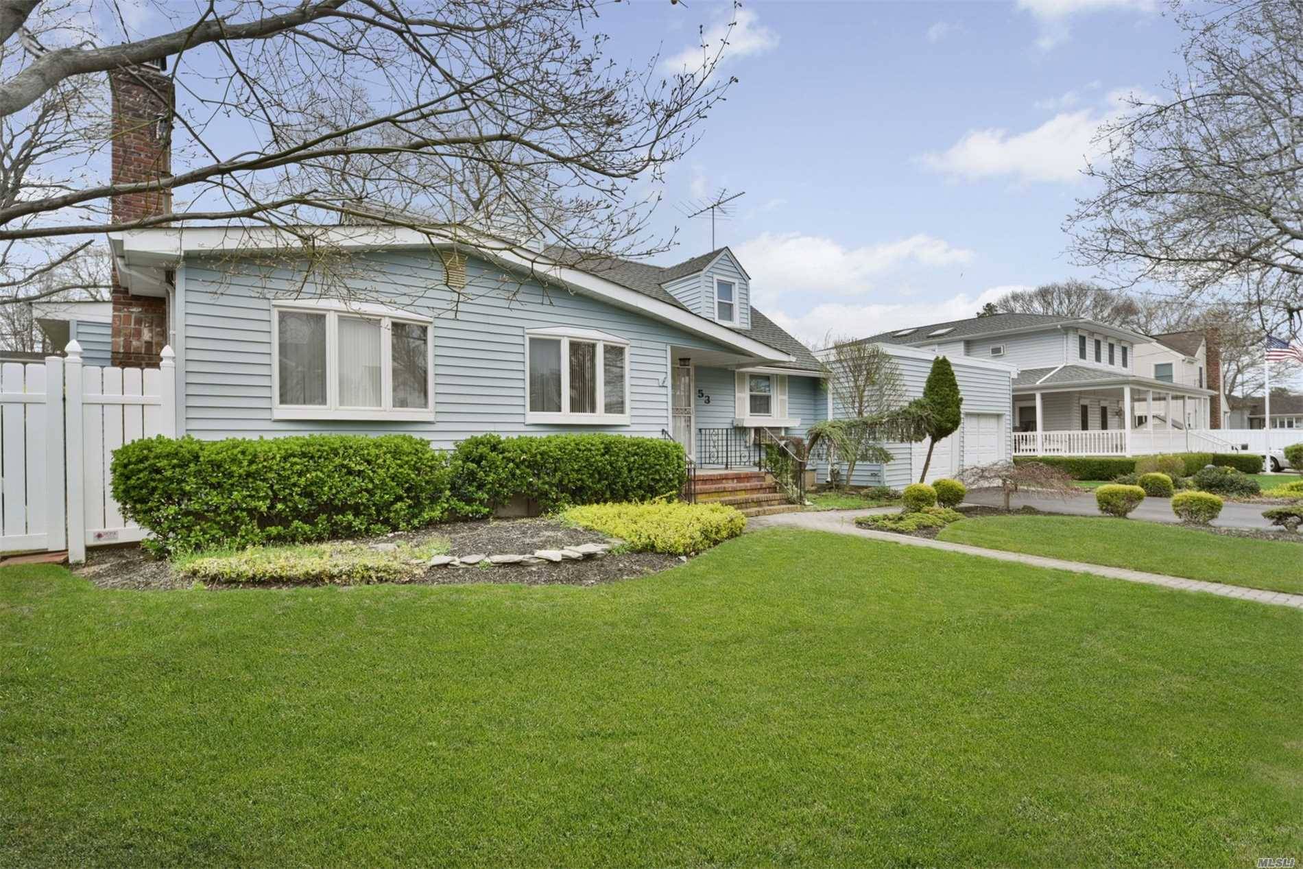 Lovely Expanded Cape Set On Oversized Property Located In Desirable Massapequa Park.