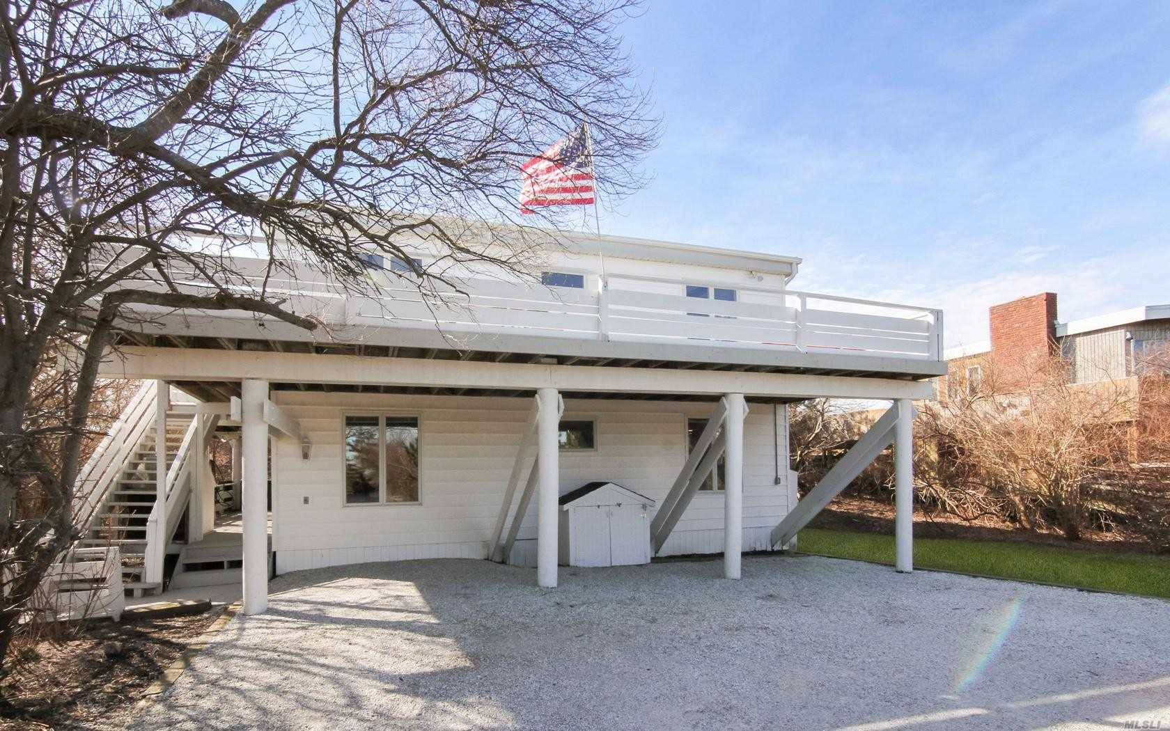 Mid Century Modern Oceanfront Bungalow 4 bedroom beach house sited on over a half acre with 78 feet of ocean frontage.