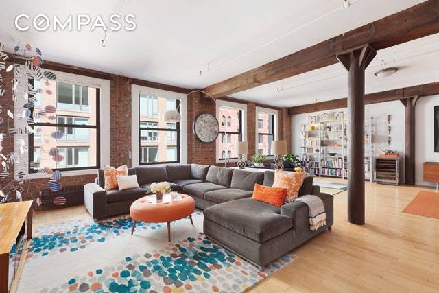 Enjoy Tribeca loft living with exposed brick walls, cast iron columns, and beams throughout this sprawling floor through home filled with architectural details on a quiet street.